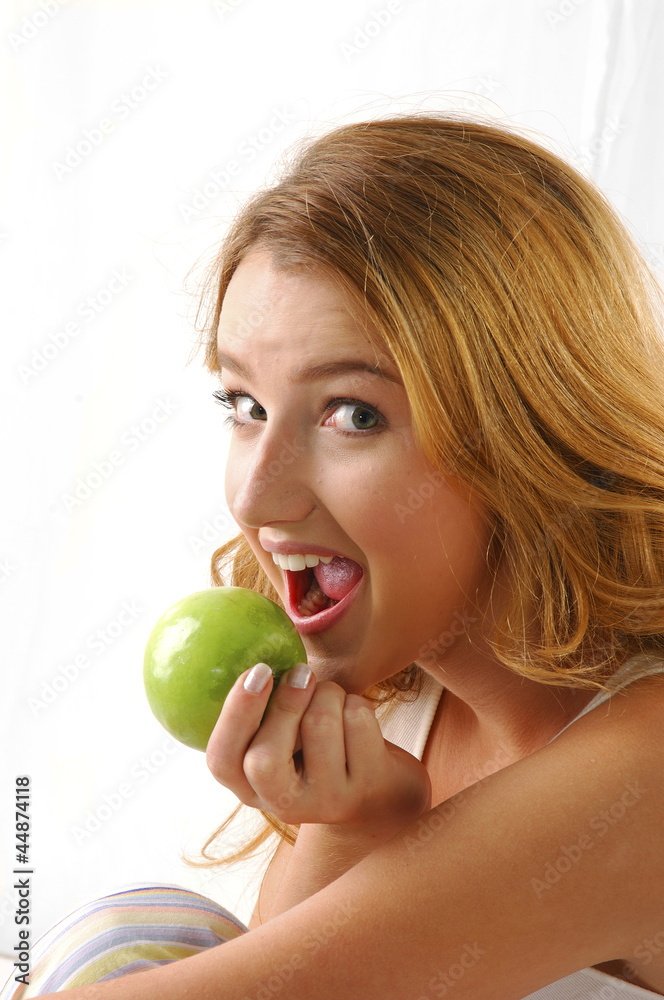Portrait of pretty girl eating green apple Portrait of pretty girl eating green apple