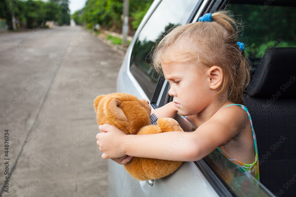 sad little girl sitting near the window in the car Stock Photo | Adobe ...
