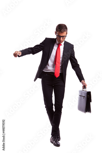 Business man balancing and walking forward photo