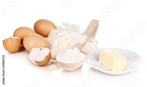 Eggs, flour and butter isolated on white