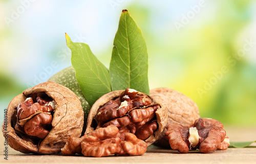 walnuts with green leaves, on green background