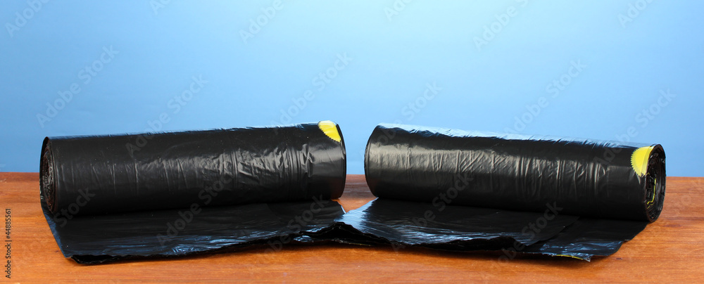 plastic garbage bags on blue background close-up