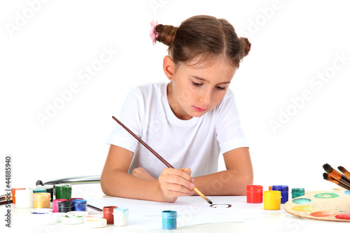 Cute little girl painting a...
