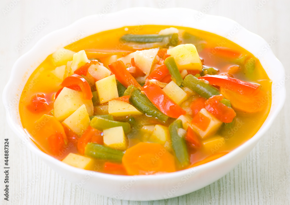 Fresh vegetable soup made of green bean, carrot, potato, red bel Fresh vegetable soup made of green bean, carrot, potato, red bel