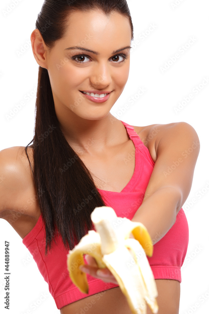 health concept - smiling brunette teenager offering banana health concept - smiling brunette teenager offering banana