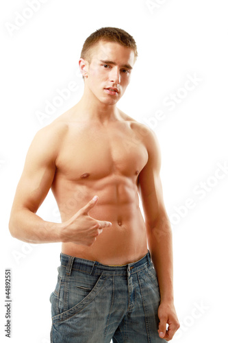 A muscular man showing his abs, isolated on white background