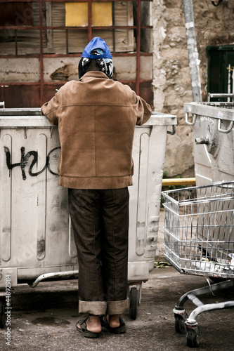 Homeless searching in trash can