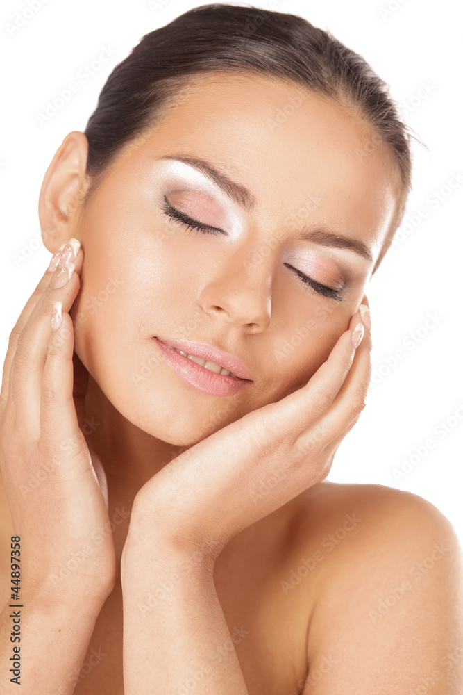 A young woman touching her face, closeup A young woman touching her face, closeup