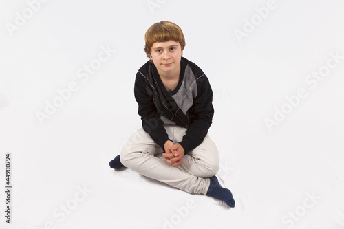 smart happy young boy posing in studio photo