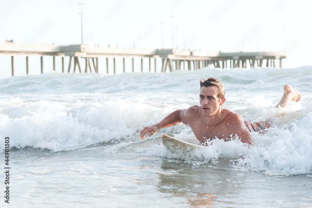 active young man surfing in the ocean active young man surfing in the ocean