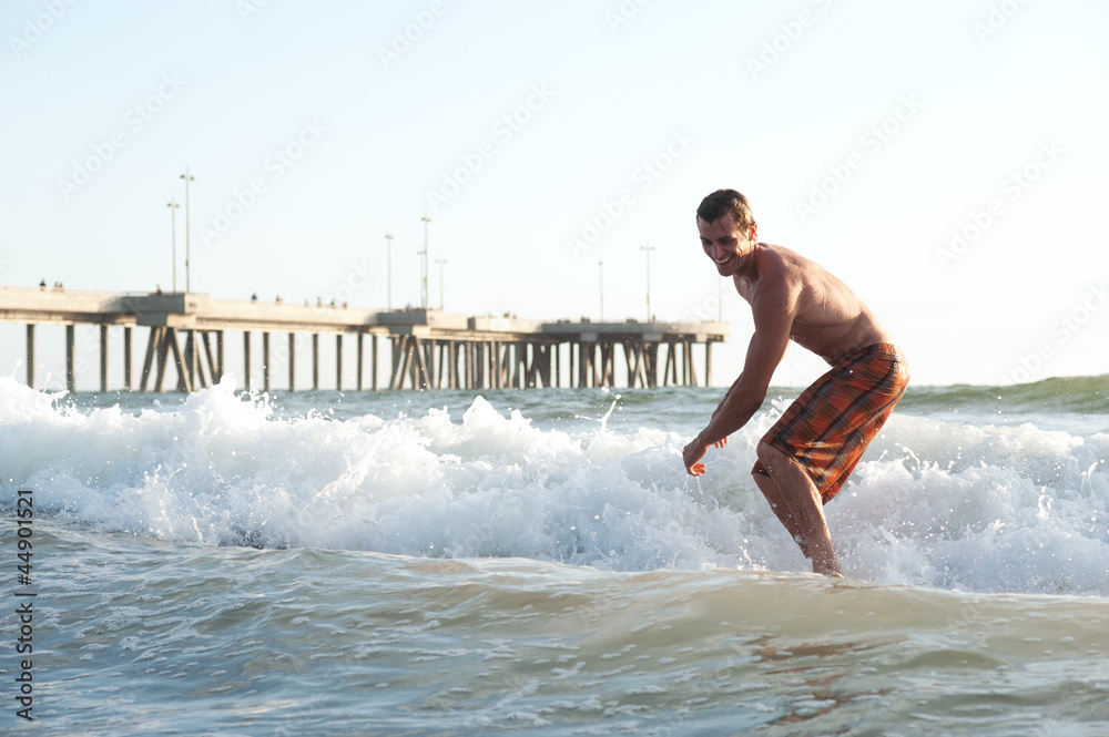 active young man surfing in the ocean