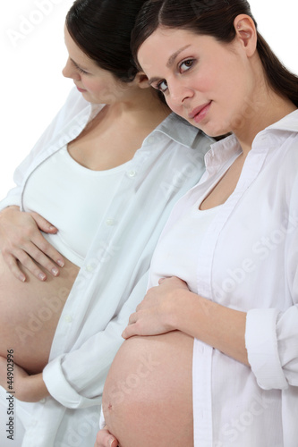 pregnant woman withhand resting on belly and side look photo