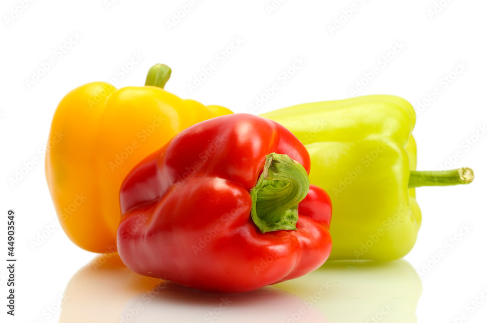 fresh yellow, red and green bell peppers isolated on white