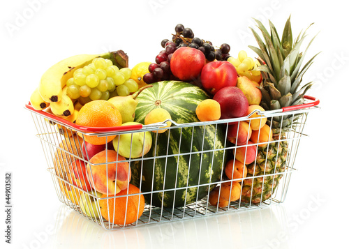 Assortment of exotic fruits in metal basket isolated on white