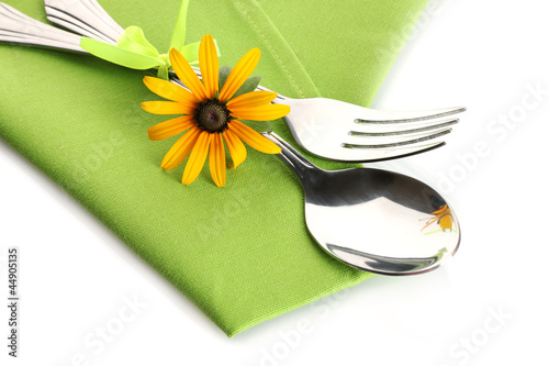 spoon, fork and flower on napkin, isolated on white