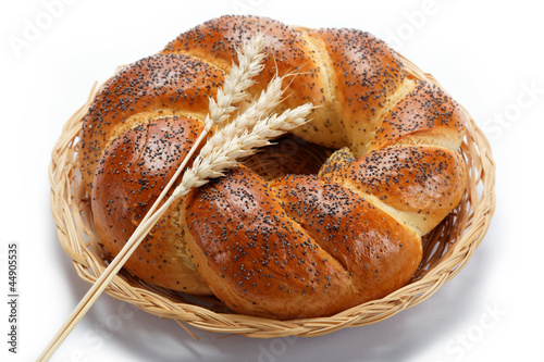 A fresh loaf of bread sprinkle with poppy seeds isolated on whit