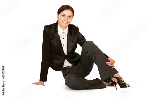 Young woman sitting on the floor , isolated on white background