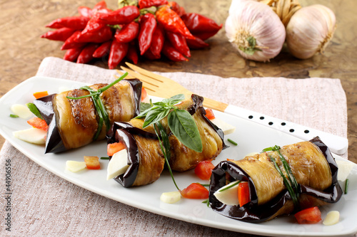 Eggplant rolls with cheese, tomato and basil