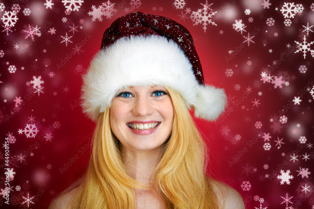 beautiful blonde girl wearing a christmas hat is smiling beautiful blonde girl wearing a christmas hat is smiling