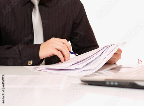 Businessman sitting on the desk photo