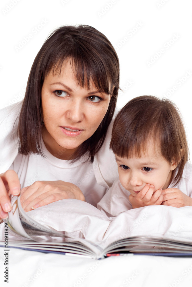 A beautiful nice Caucasian mother with her daughter lying with a A beautiful nice Caucasian mother with her daughter lying with a