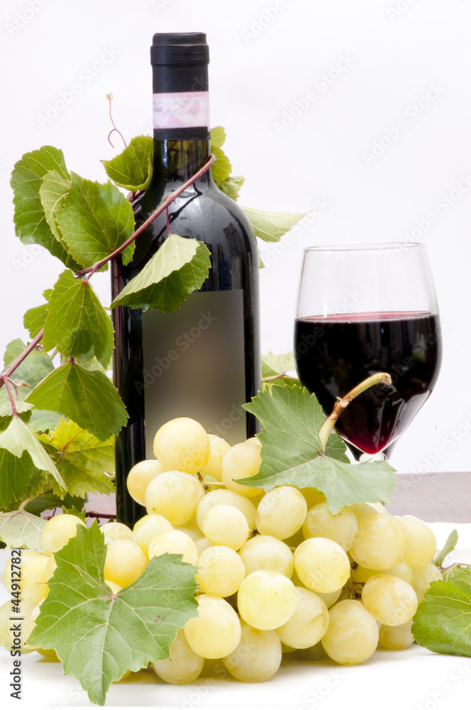 bottle of wine with grapes isolated on white