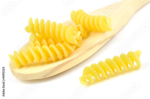 Uncooked fusilli in a wooden spoon,  italian pasta