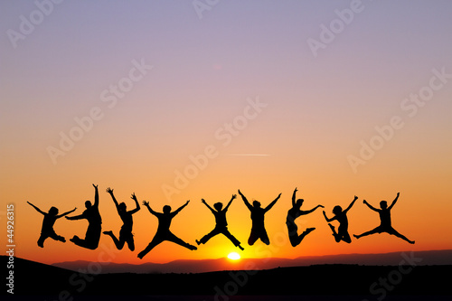 silhouette of friends jumping in sunset for fun © Alex Koch