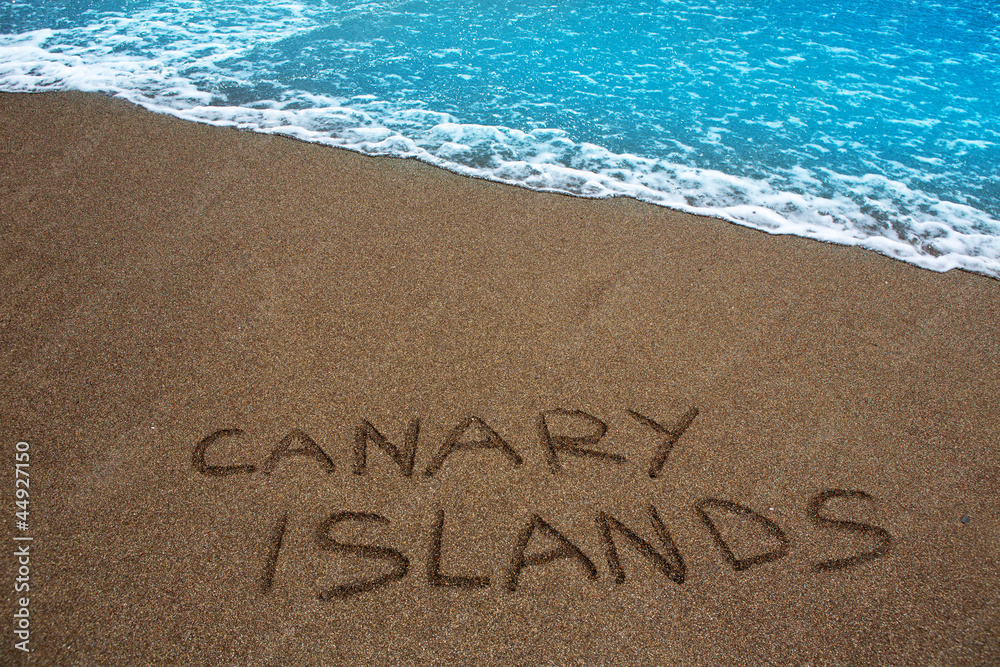 Fototapeta premium Brown beach sand written word Canary islands
