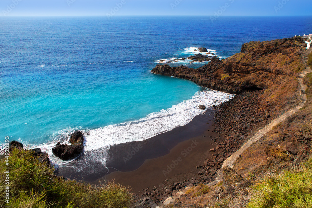 Beach el Bollullo black brown sand and aqua water Beach el Bollullo black brown sand and aqua water