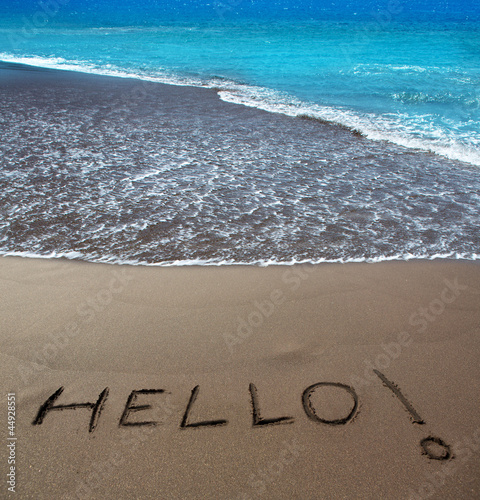 Brown sand beach with written word Hello