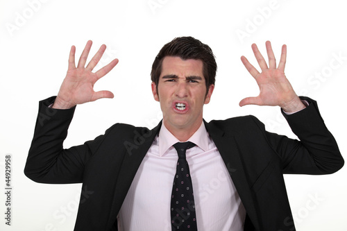 Businessman with his hands raised