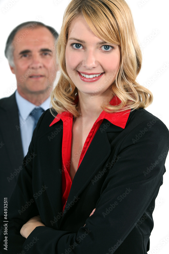 Young businesswoman in front of an older businessman Young businesswoman in front of an older businessman