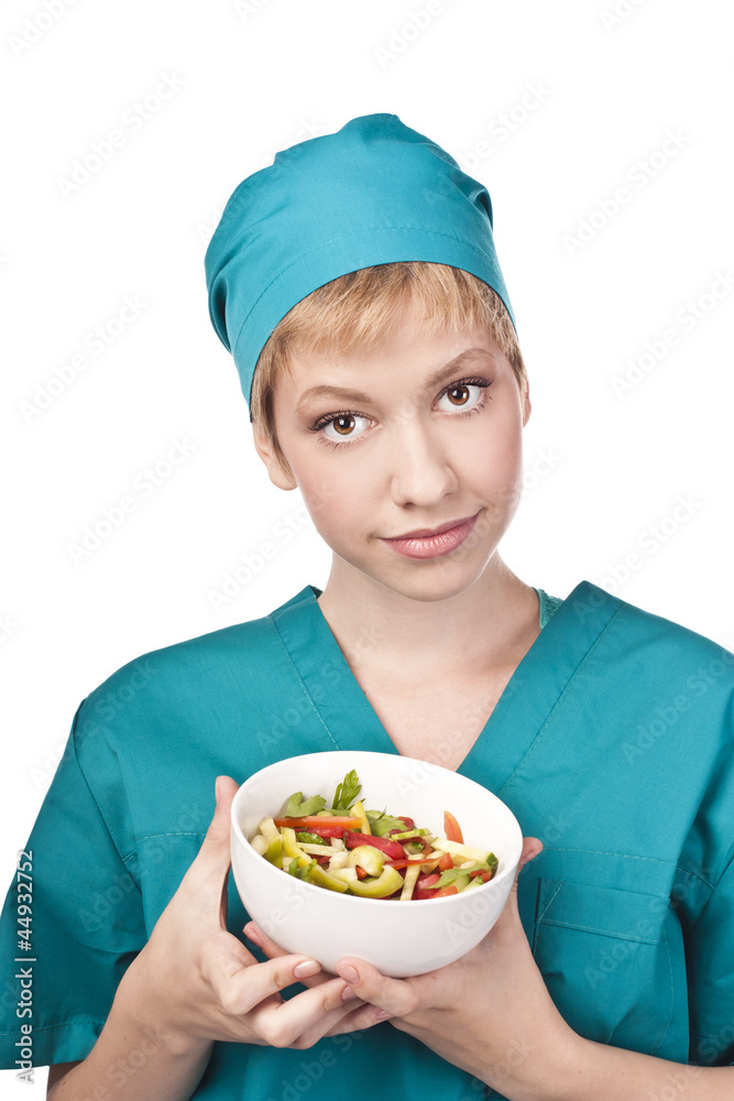 Useful vegetarian salad. Young doctor in the studio Useful vegetarian salad. Young doctor in the studio