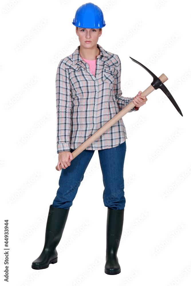 A female construction worker with a pickaxe. A female construction worker with a pickaxe.