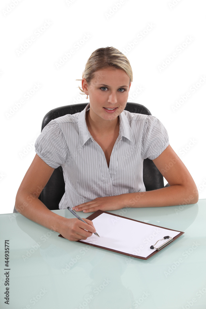 student writing on notepad