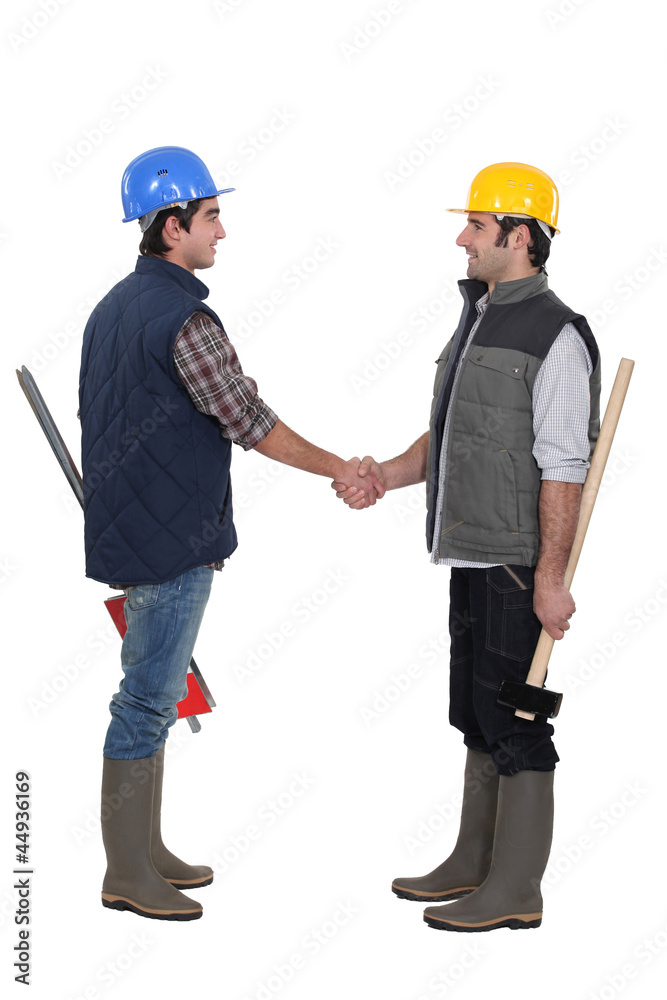 Two manual workers greeting each other Two manual workers greeting each other