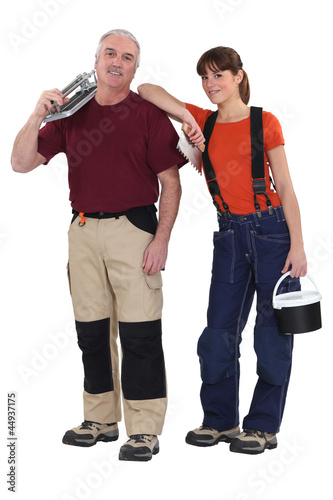 A team of tile fitters holding tools