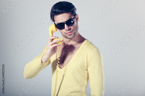 funny call center guy with hipster glasses and colouful phones photo