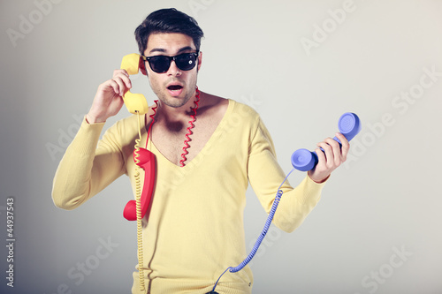 funny call center guy with hipster glasses and colouful phones photo