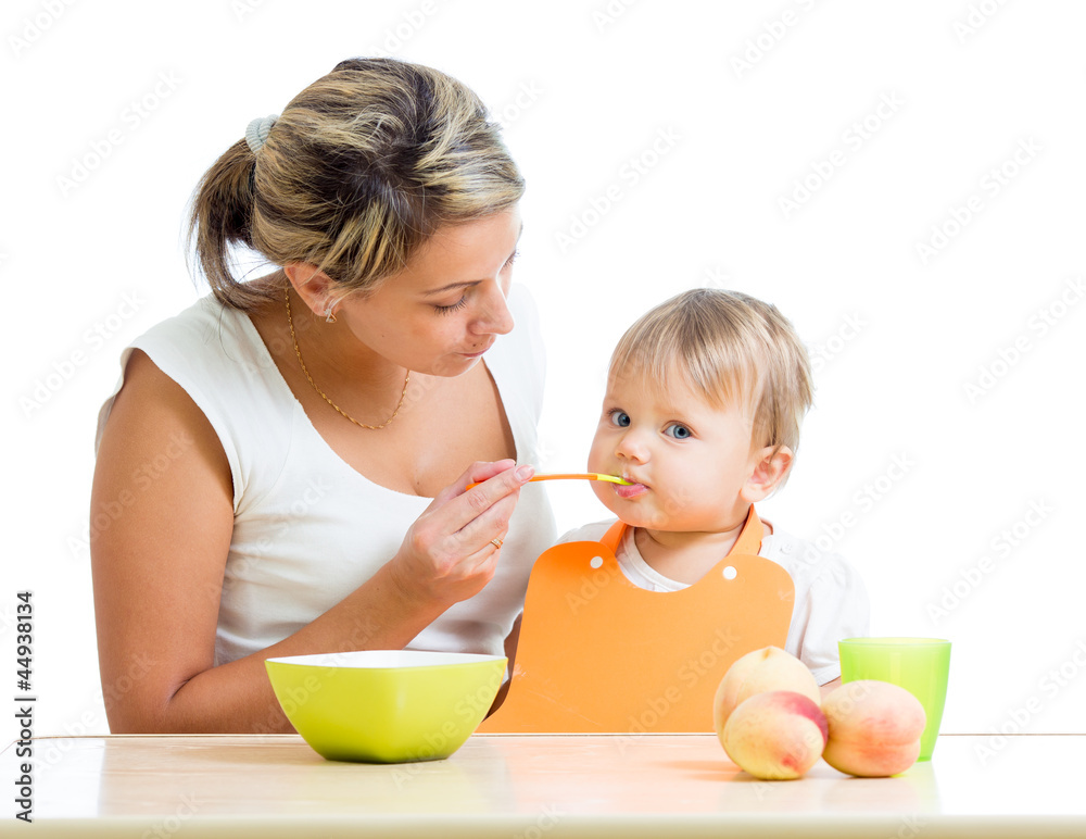 mother feeding her baby girl by spoon mother feeding her baby girl by spoon