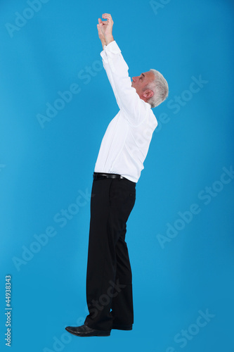 Businessman reaching up