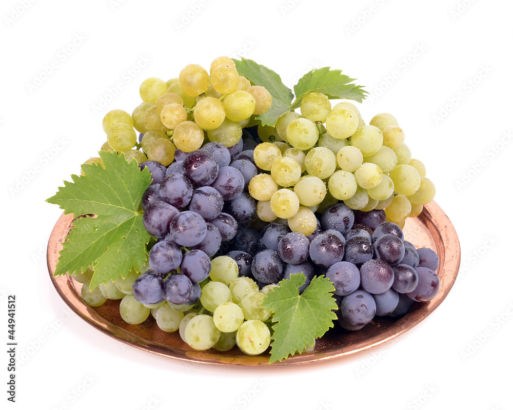 Black and white grapes in a metal bowl isolated ,drops Black and white grapes in a metal bowl isolated ,drops