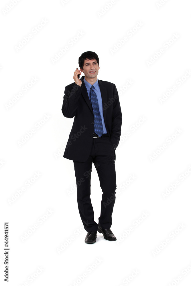 Full length businessman on the phone Full length businessman on the phone
