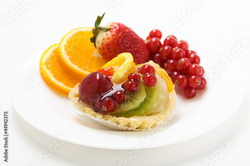 Cupcake with fruits on the white plate