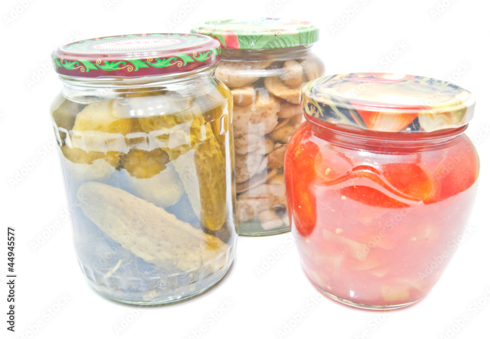 three jars with marinated vegetables three jars with marinated vegetables