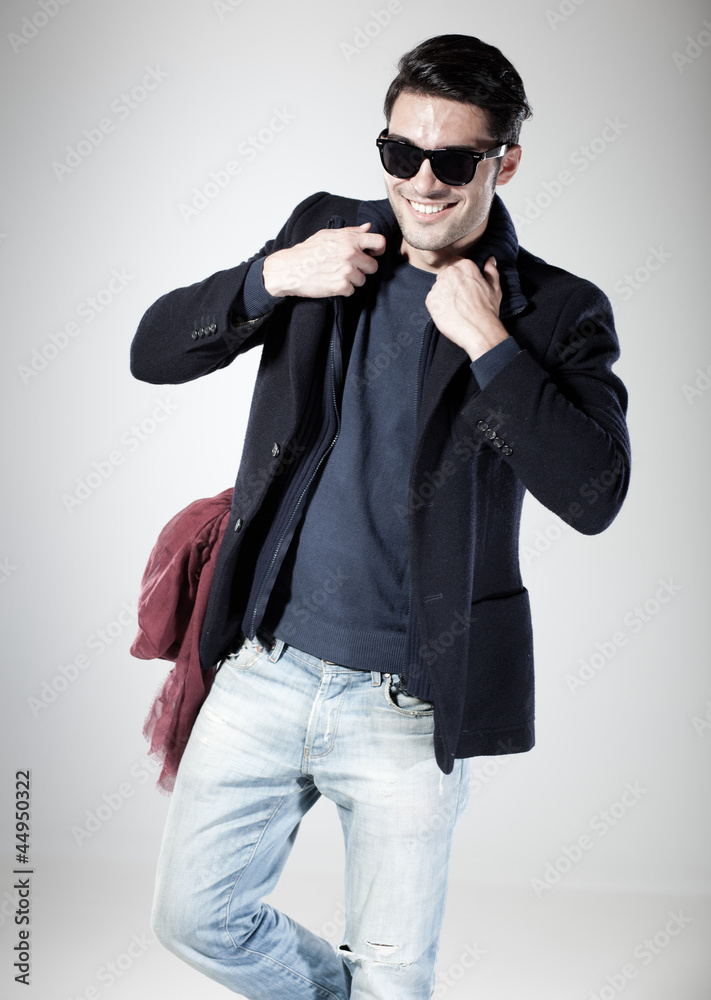 Obraz premium attractive man smiling and posing in the studio