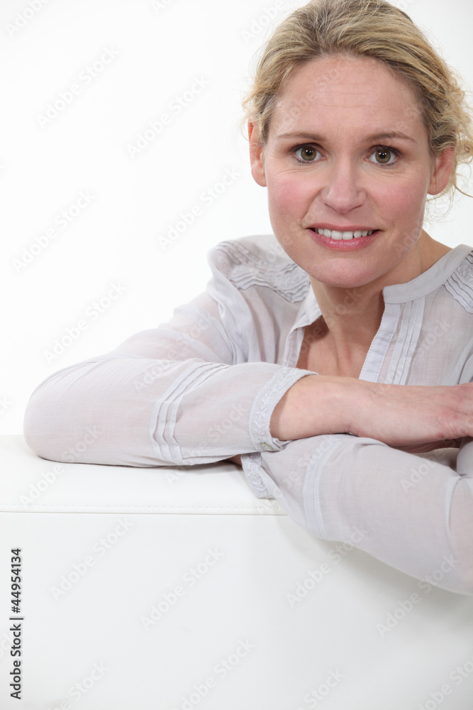 portrait of beautiful blonde in her thirties posing cross-armed portrait of beautiful blonde in her thirties posing cross-armed