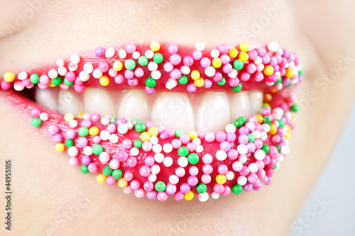 Womans lips with colored candy
