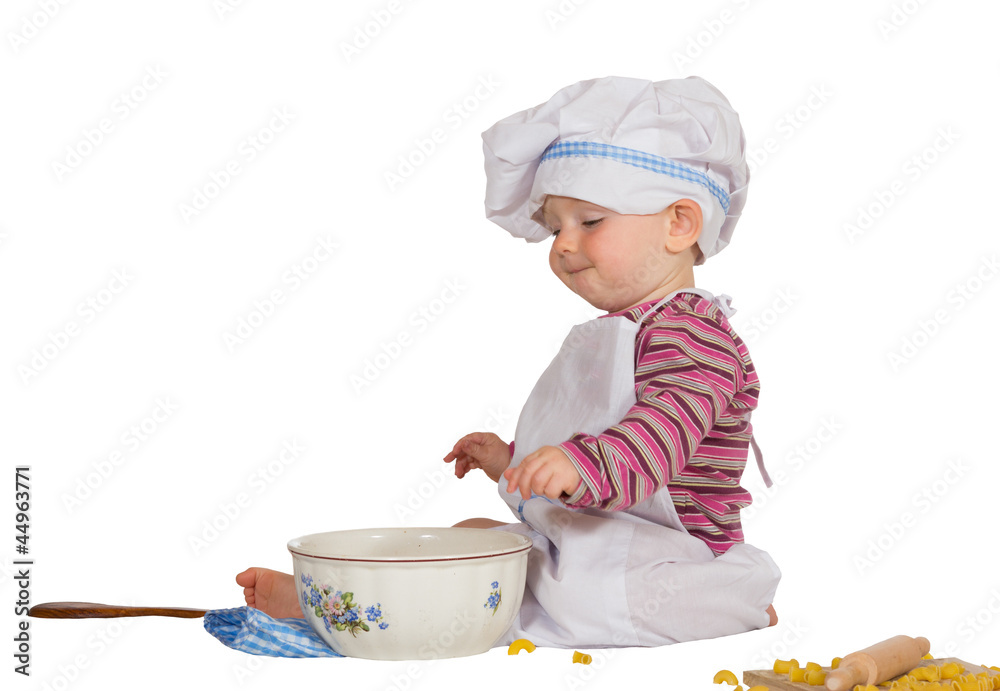 Satisfied little baby chef looking at mixing bowl Satisfied little baby chef looking at mixing bowl